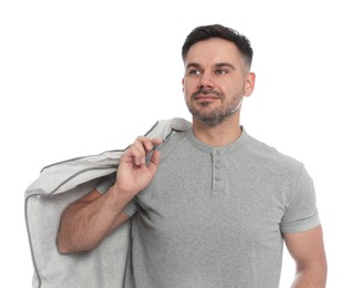 Photo of Man holding garment cover with clothes on white background. Dry-cleaning service