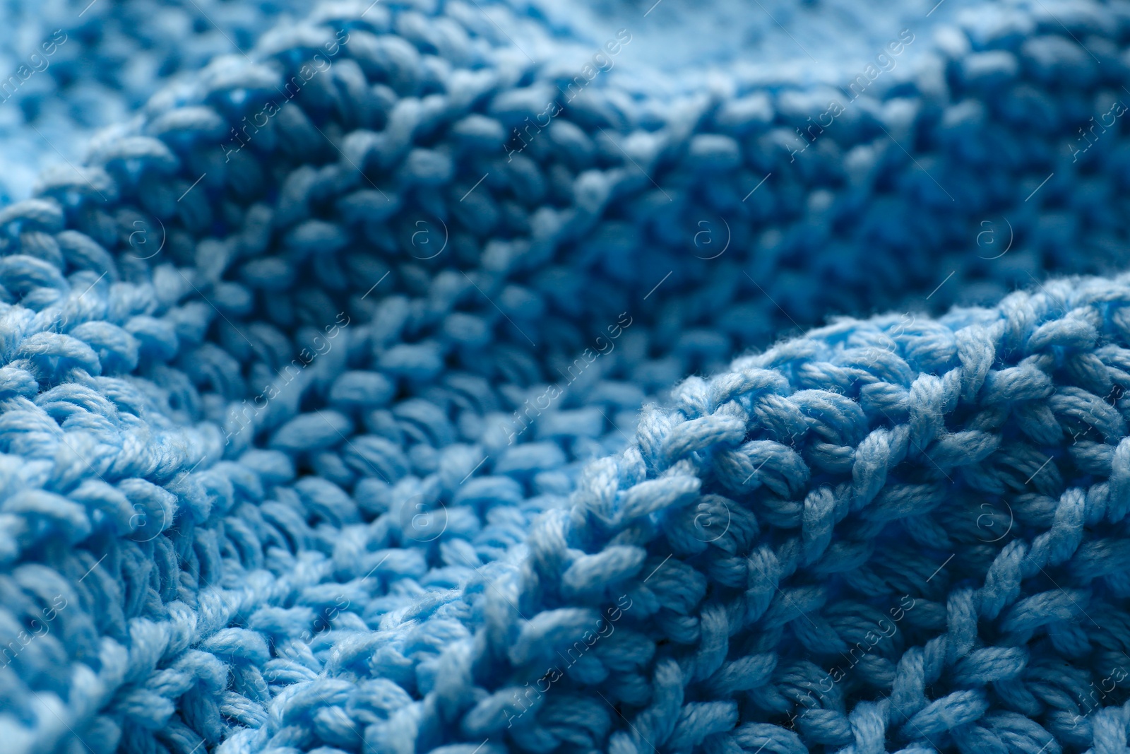 Photo of Beautiful light blue knitted fabric as background, closeup