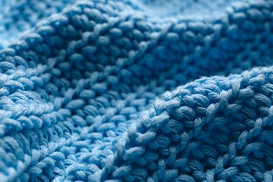 Beautiful light blue knitted fabric as background, closeup