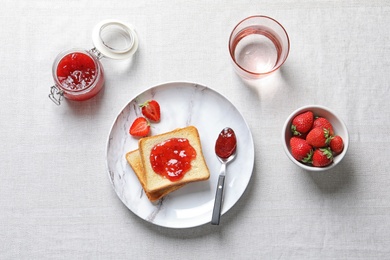 Photo of Flat lay composition with toast bread, strawberries and jam on table