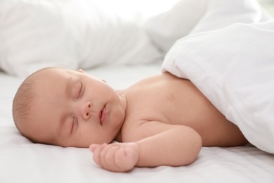 Photo of Cute little baby sleeping on bed, closeup