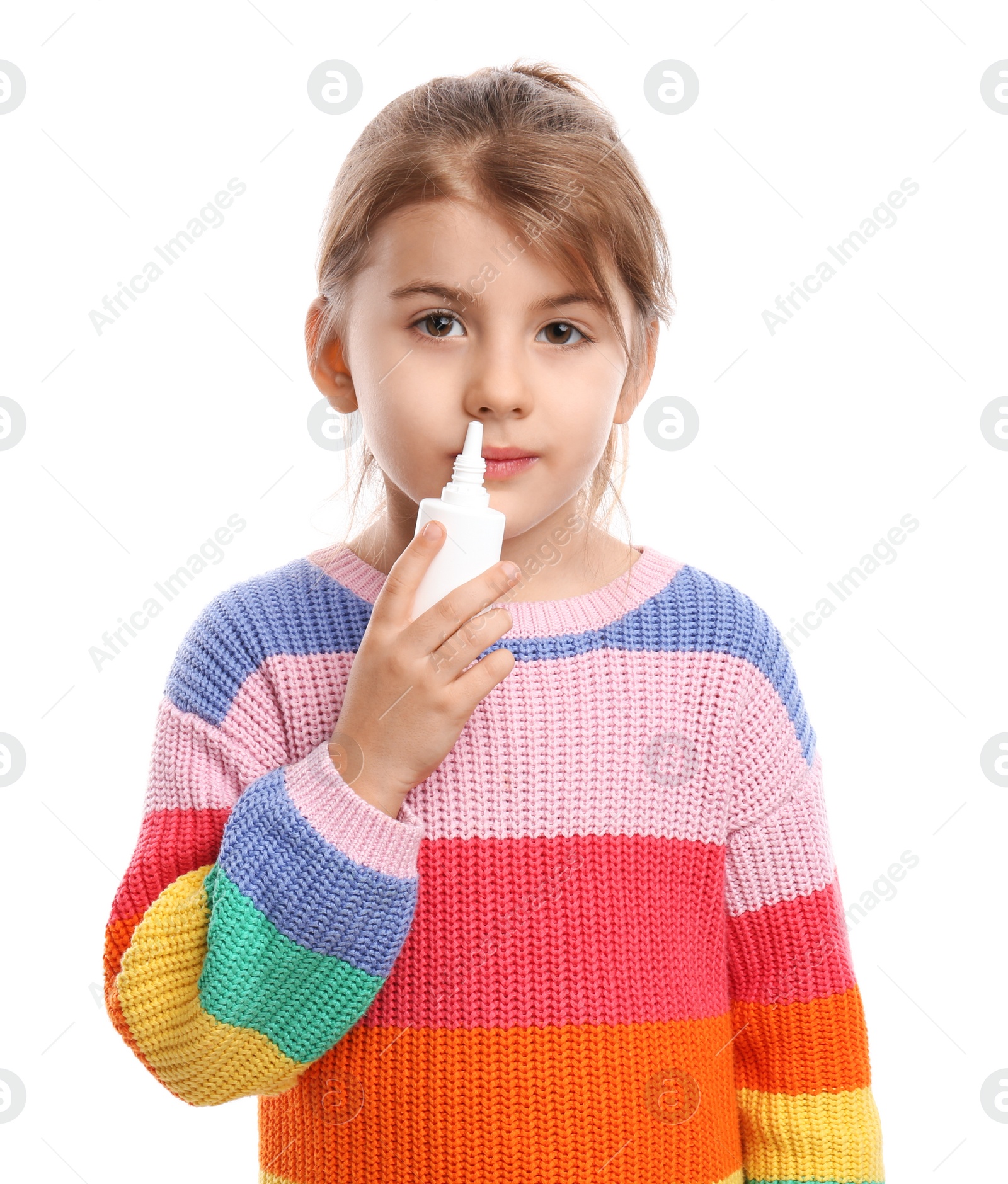 Photo of Sick little girl using nasal spray on white background