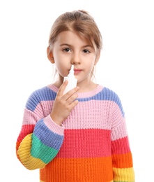 Photo of Sick little girl using nasal spray on white background