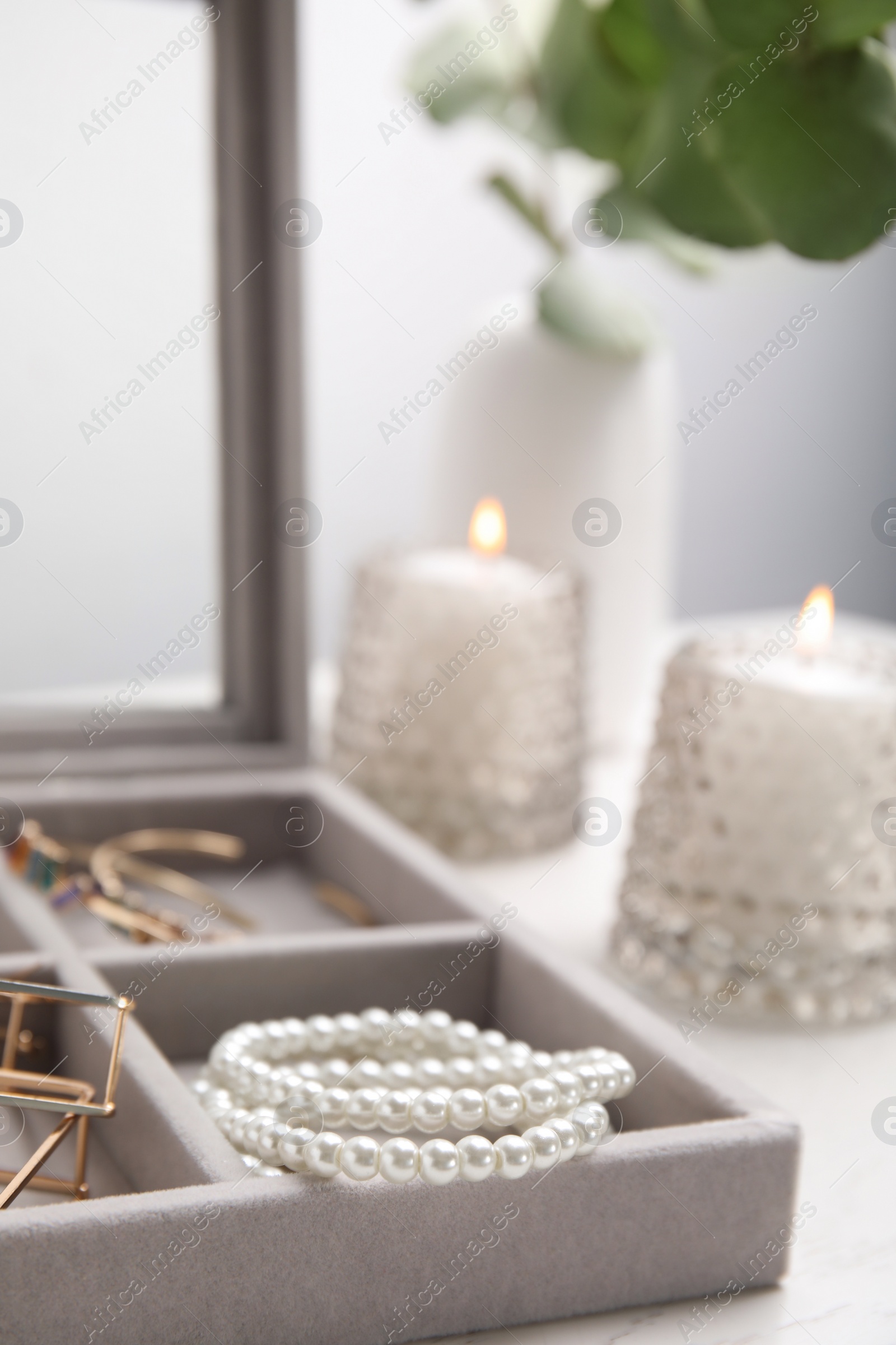 Photo of Elegant jewelry box with beautiful bijouterie on table, closeup