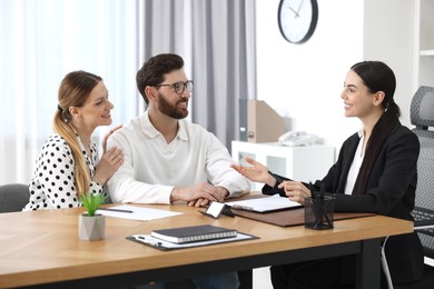 Photo of Couple having meeting with lawyer in office