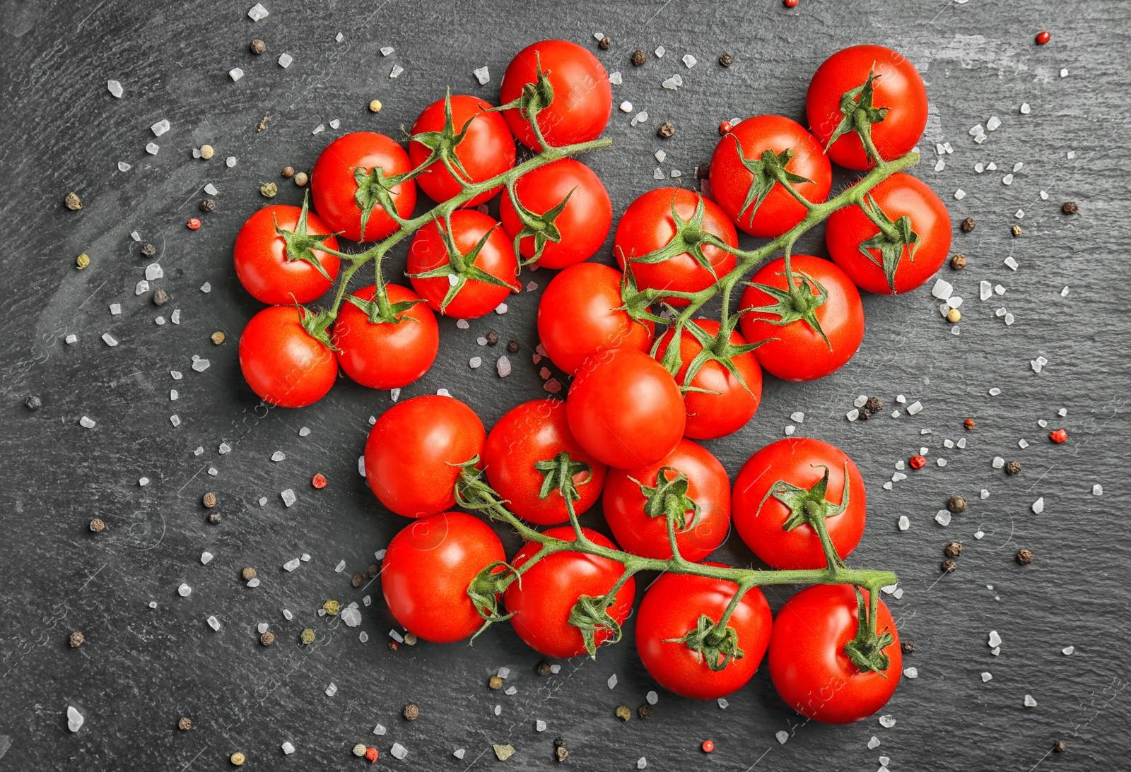 Photo of Slate plate with fresh ripe tomatoes on table, top view