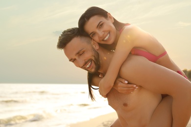 Photo of Happy young couple having fun on beach on sunny day
