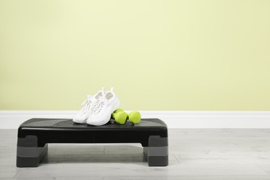 Photo of Step platform and sports equipment indoors. Space for text