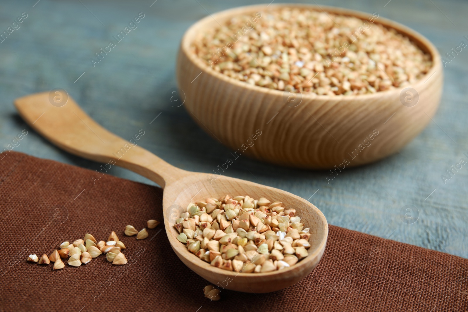 Photo of Uncooked green buckwheat grains on table, closeup