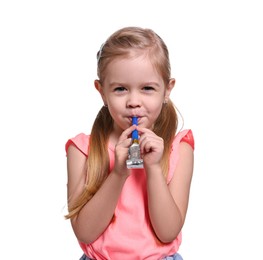 Photo of Birthday celebration. Cute little girl with blower on white background