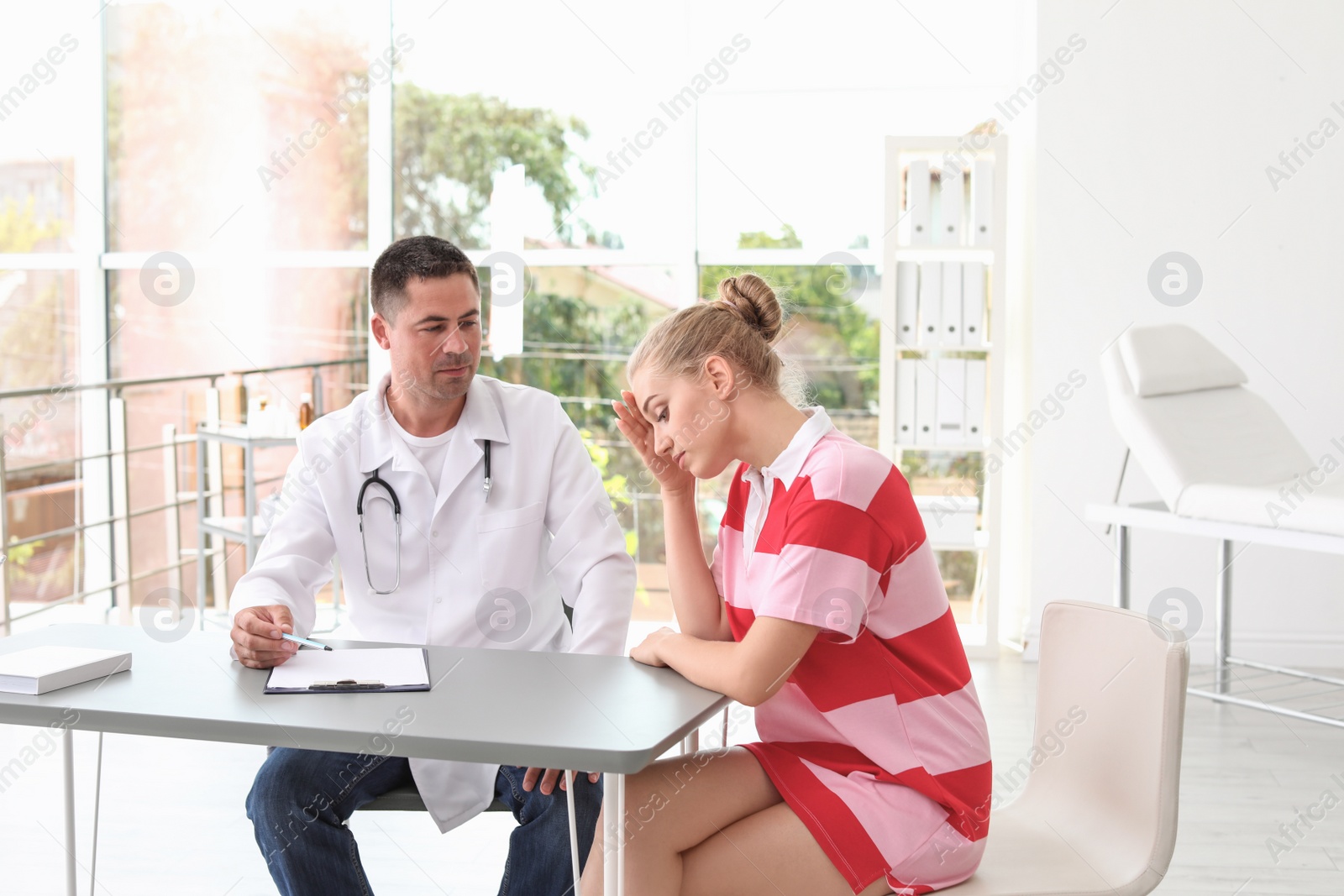 Photo of Patient having appointment with doctor in hospital