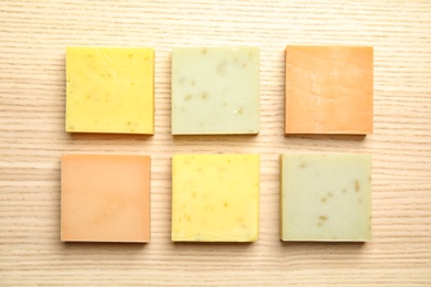 Photo of Hand made soap bars on wooden background