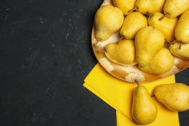 Photo of Flat lay composition with fresh ripe pears and space for text on dark background