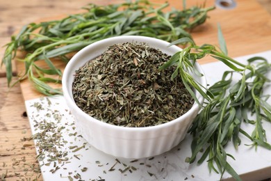 Dry and fresh tarragon on table, closeup