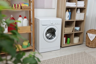 Photo of Laundry room interior with washing machine and furniture