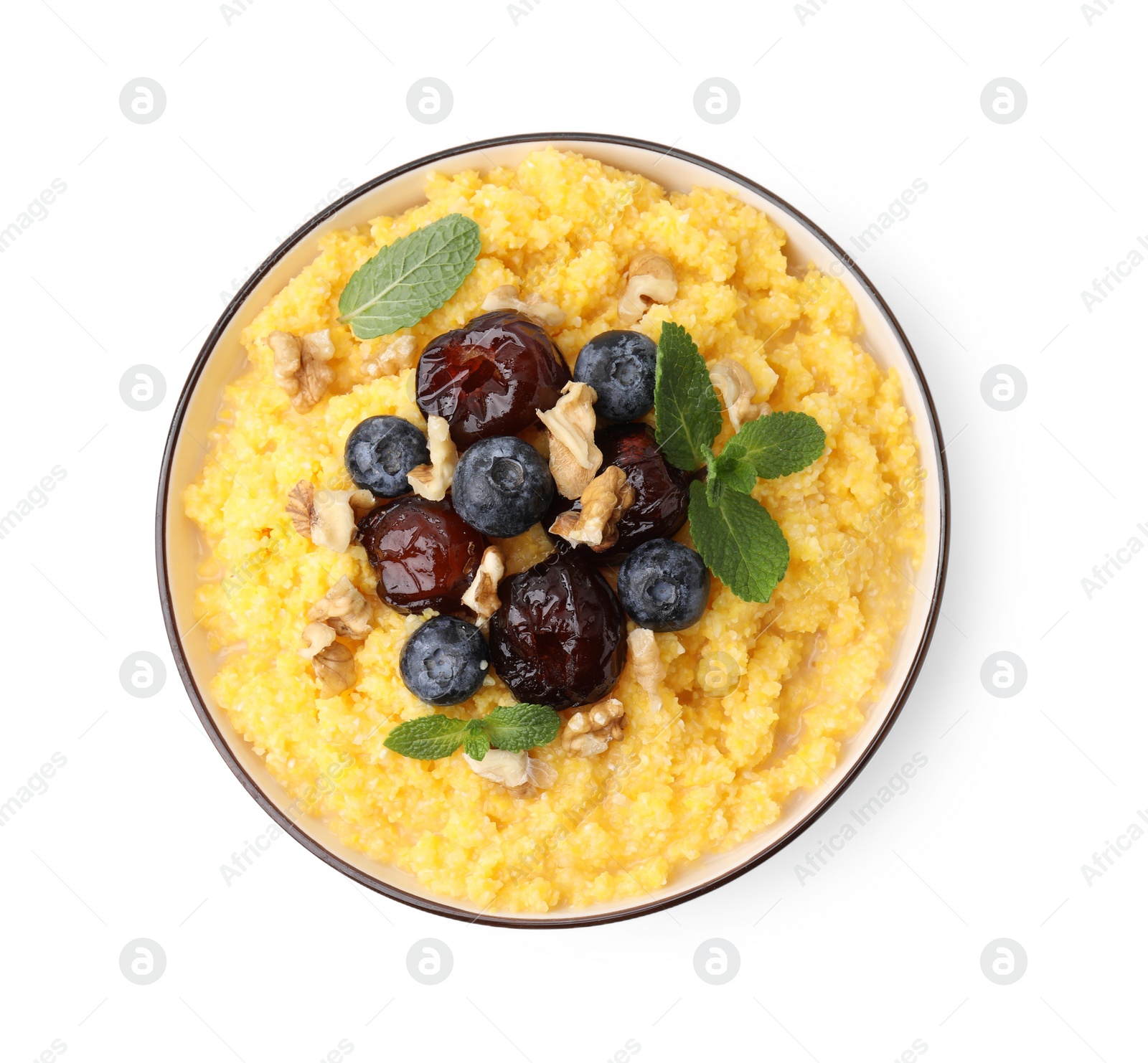 Photo of Tasty cornmeal with blueberries, dates, walnuts and mint in bowl isolated on white, top view