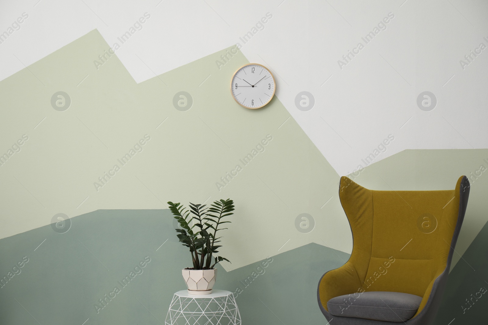 Photo of Big clock hanging on color wall. Time concept