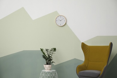 Big clock hanging on color wall. Time concept