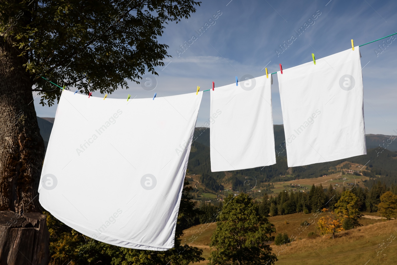 Photo of Laundry with clothes pins on line outdoors