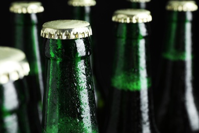 Green bottles of tasty cold beer, closeup. Space for text