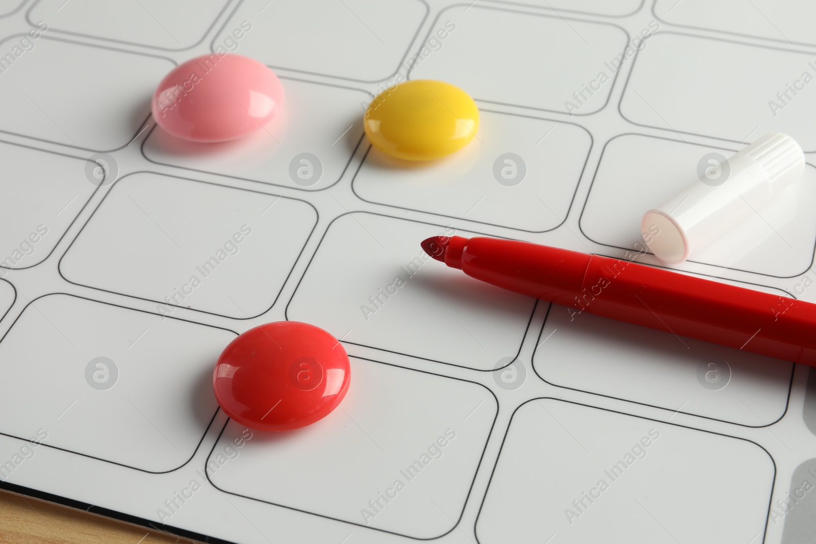 Photo of Timetable. Planner, felt pen and drawing pins on table, closeup