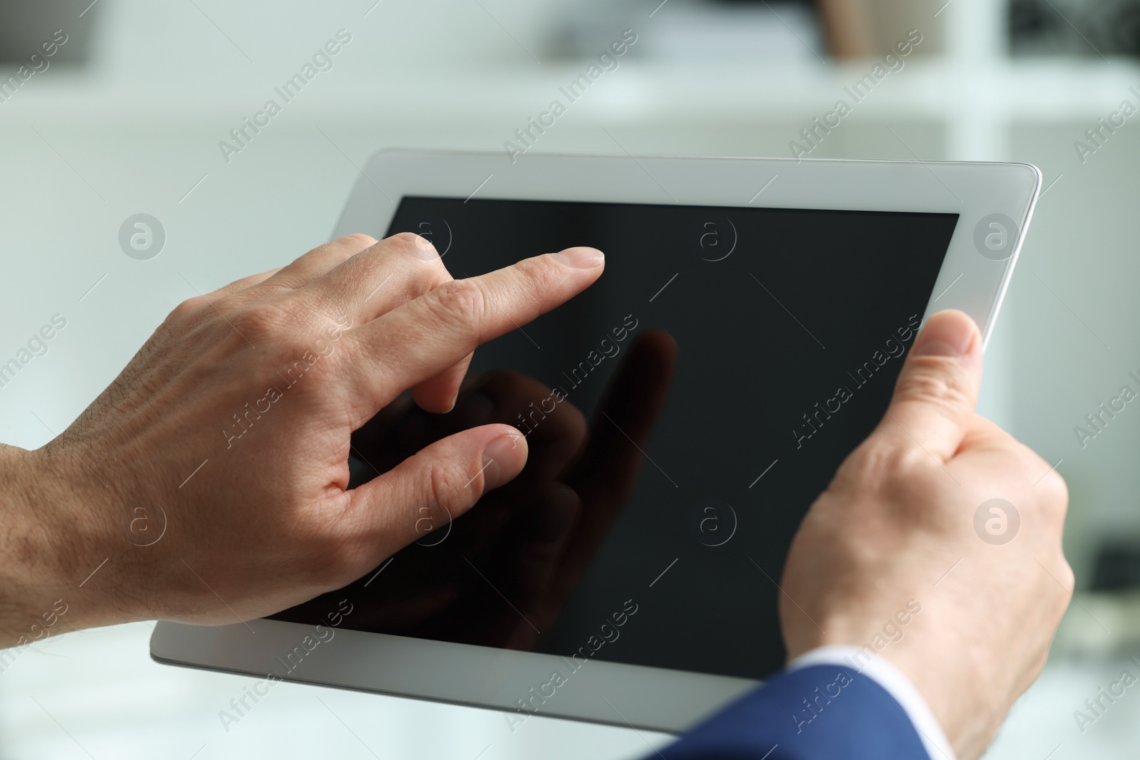 Photo of Closeup view of man using new tablet indoors