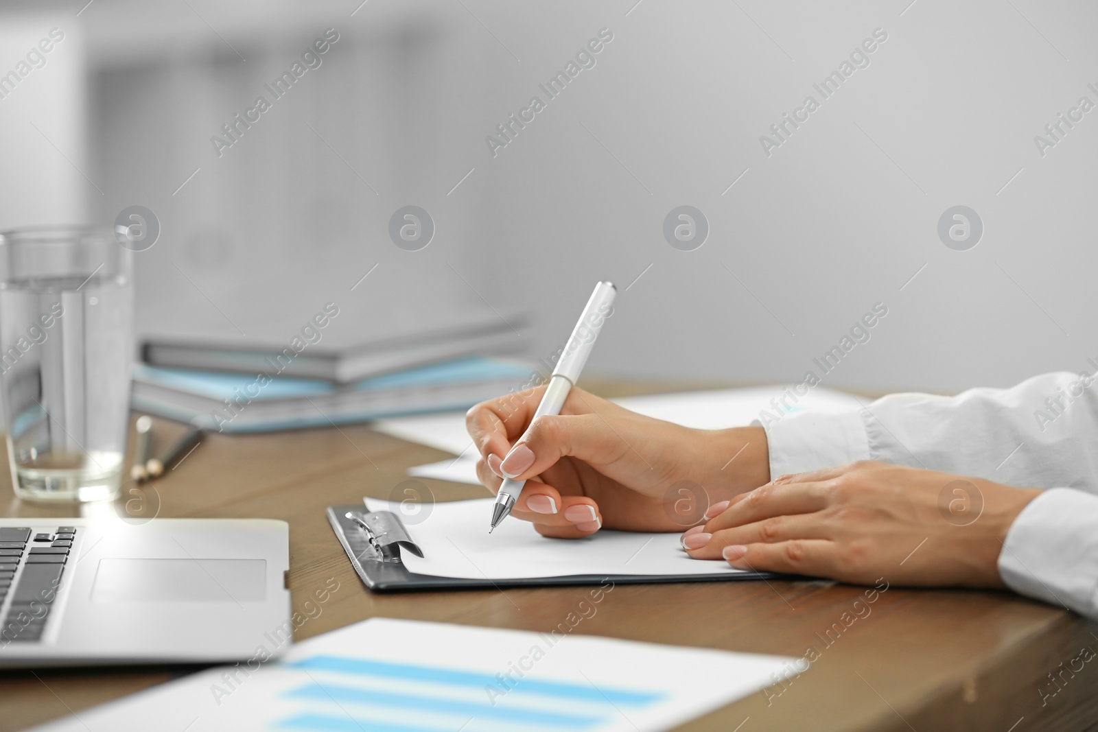 Photo of Business trainer working at table in office, closeup