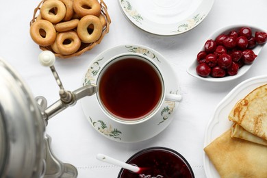 Photo of Cup of aromatic tea and treats on table, flat lay