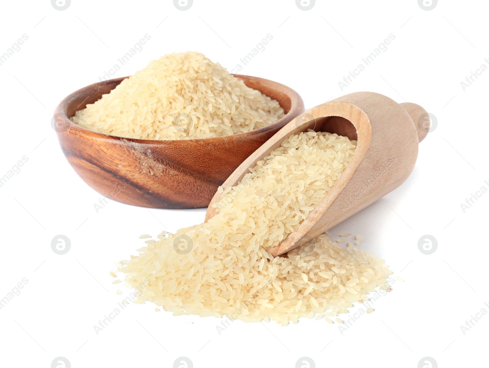 Photo of Bowl and scoop with uncooked parboiled rice on white background