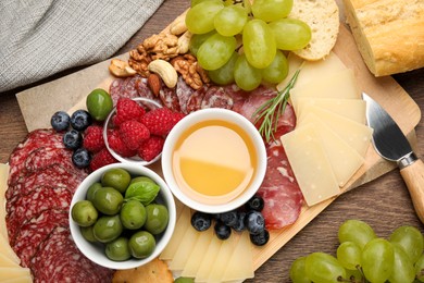 Snack set with delicious Parmesan cheese on wooden table, flat lay