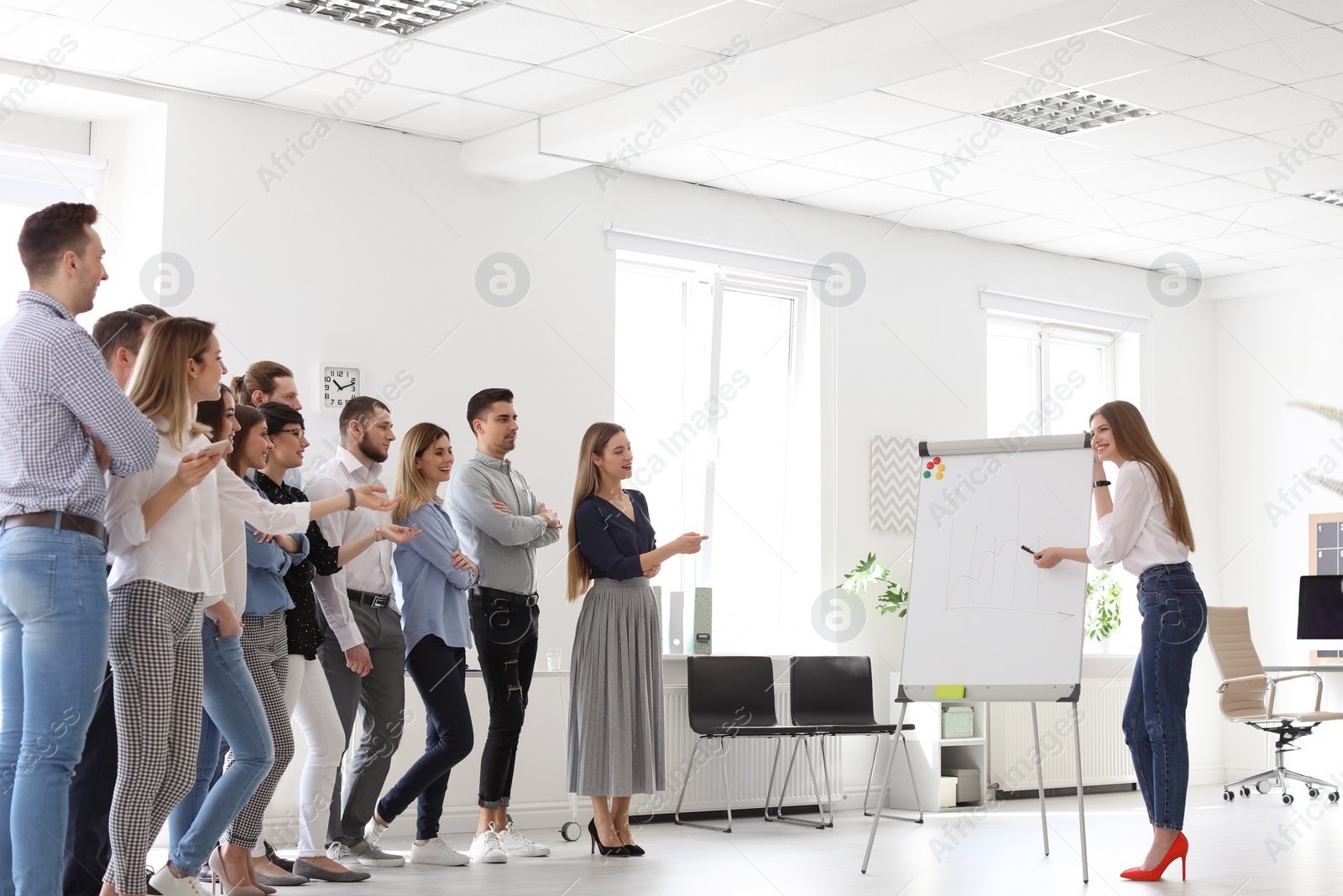 Photo of Female business trainer giving lecture in office