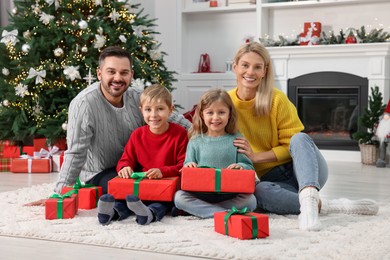 Happy family with Christmas gifts at home