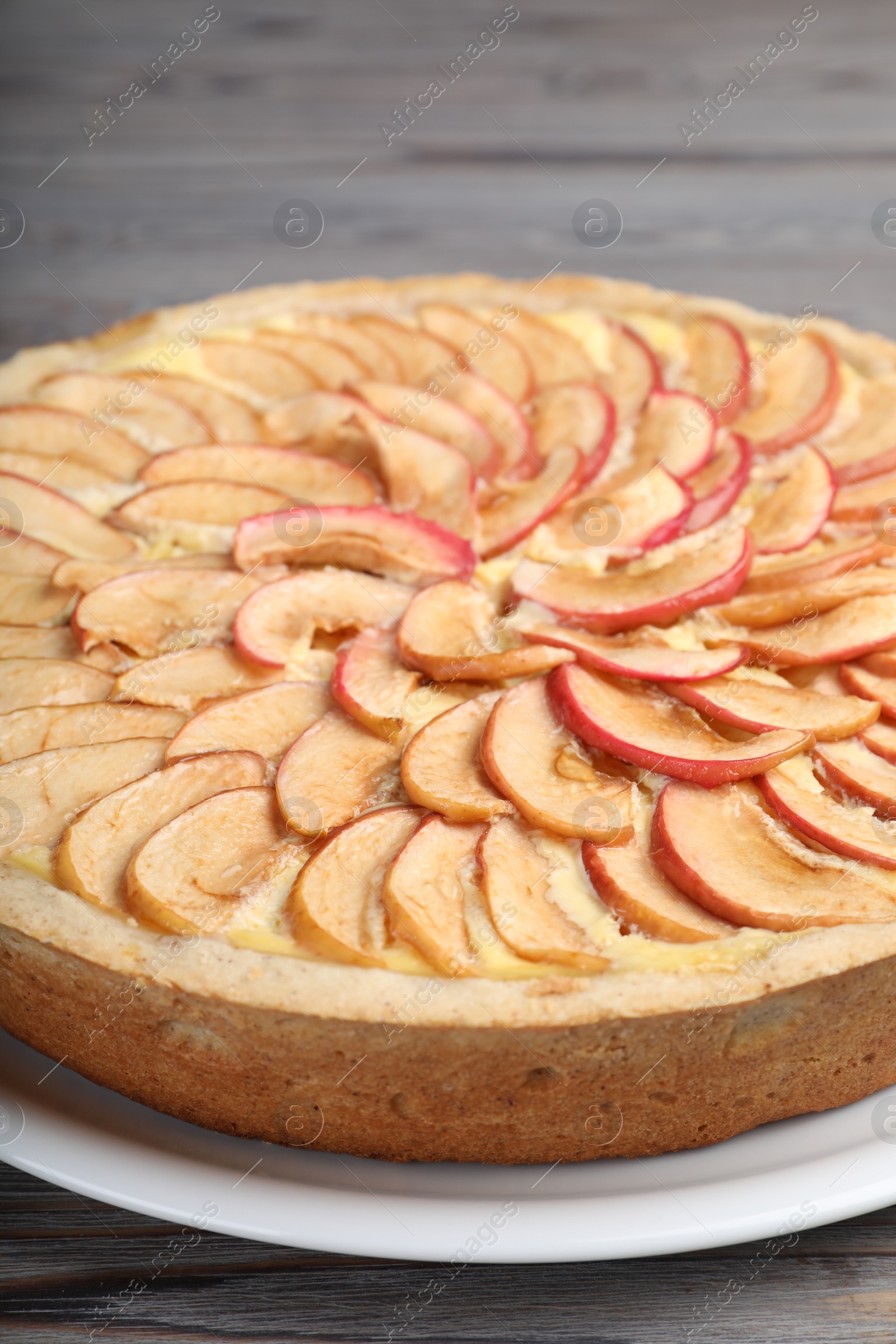 Photo of Freshly baked delicious apple pie on wooden table, closeup