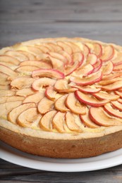 Photo of Freshly baked delicious apple pie on wooden table, closeup