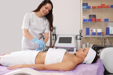 Photo of Young woman undergoing radio frequency lifting procedure in beauty salon