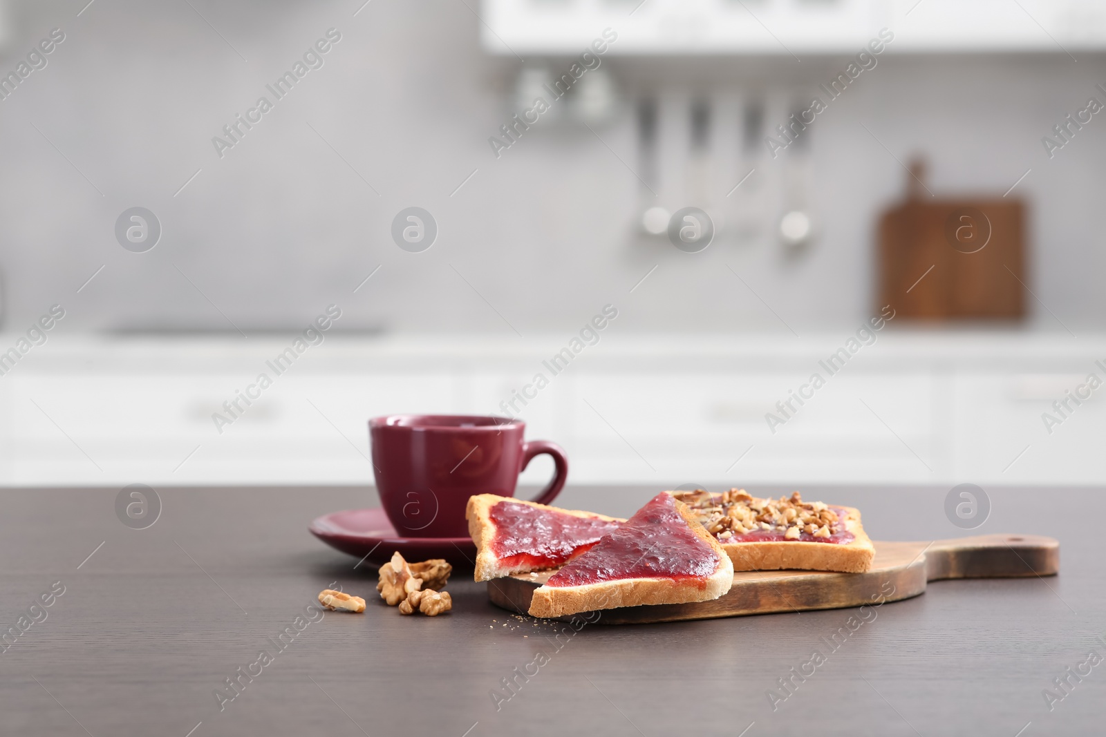 Photo of Delicious toasts and cup of drink on counter in kitchen