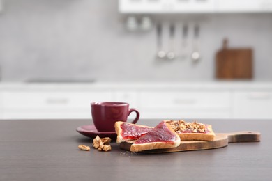 Delicious toasts and cup of drink on counter in kitchen