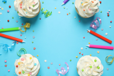 Photo of Flat lay composition with cupcakes on light blue background, space for text. Birthday party