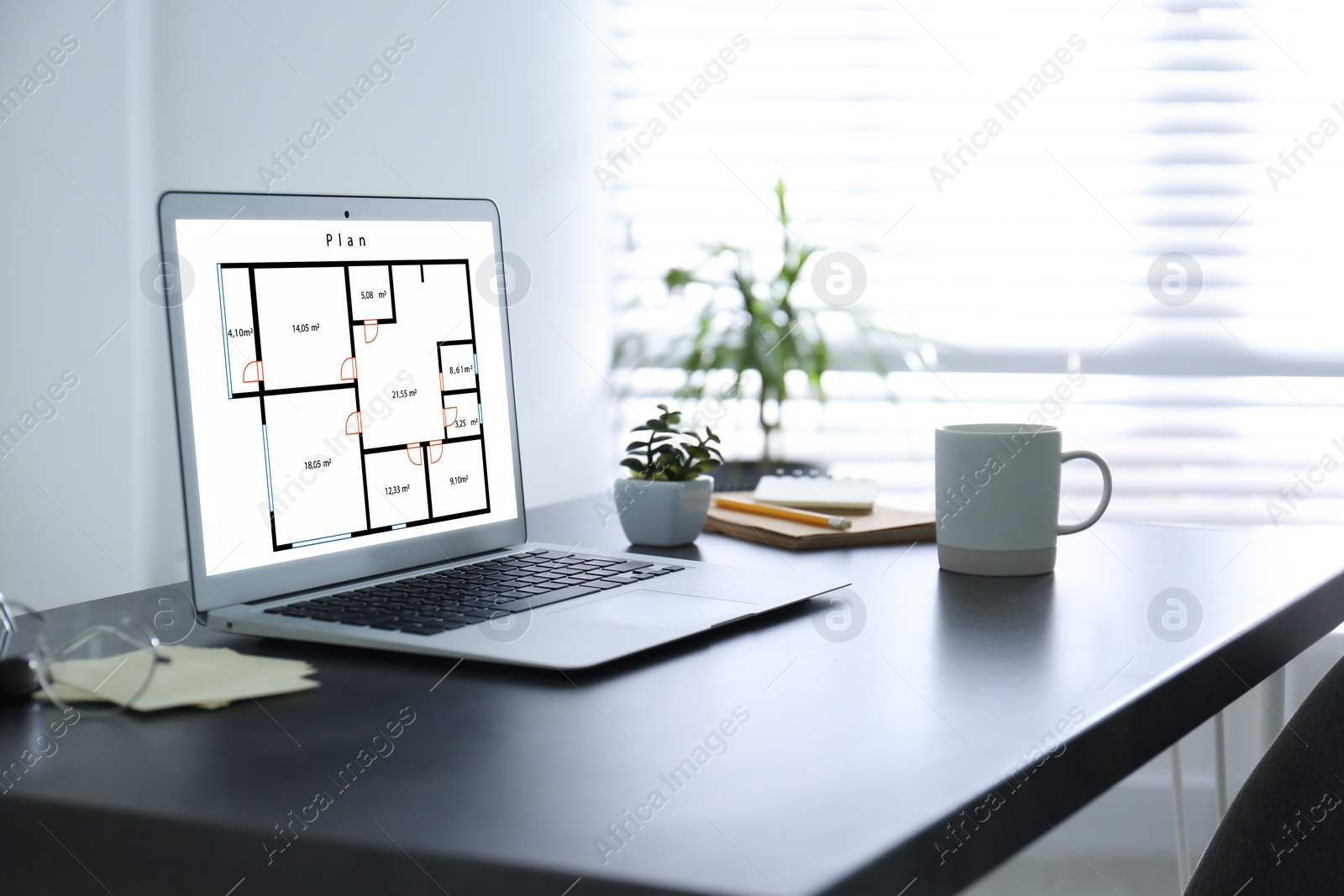 Image of Engineer's workplace. Modern laptop with house planning on display