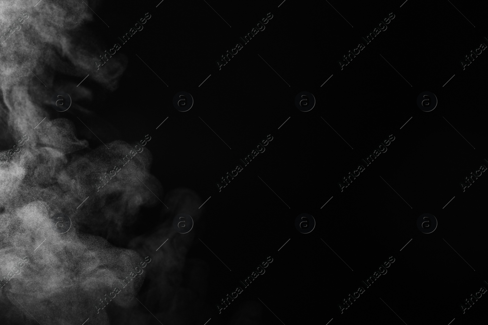 Photo of White steam rising on black background. Space for text