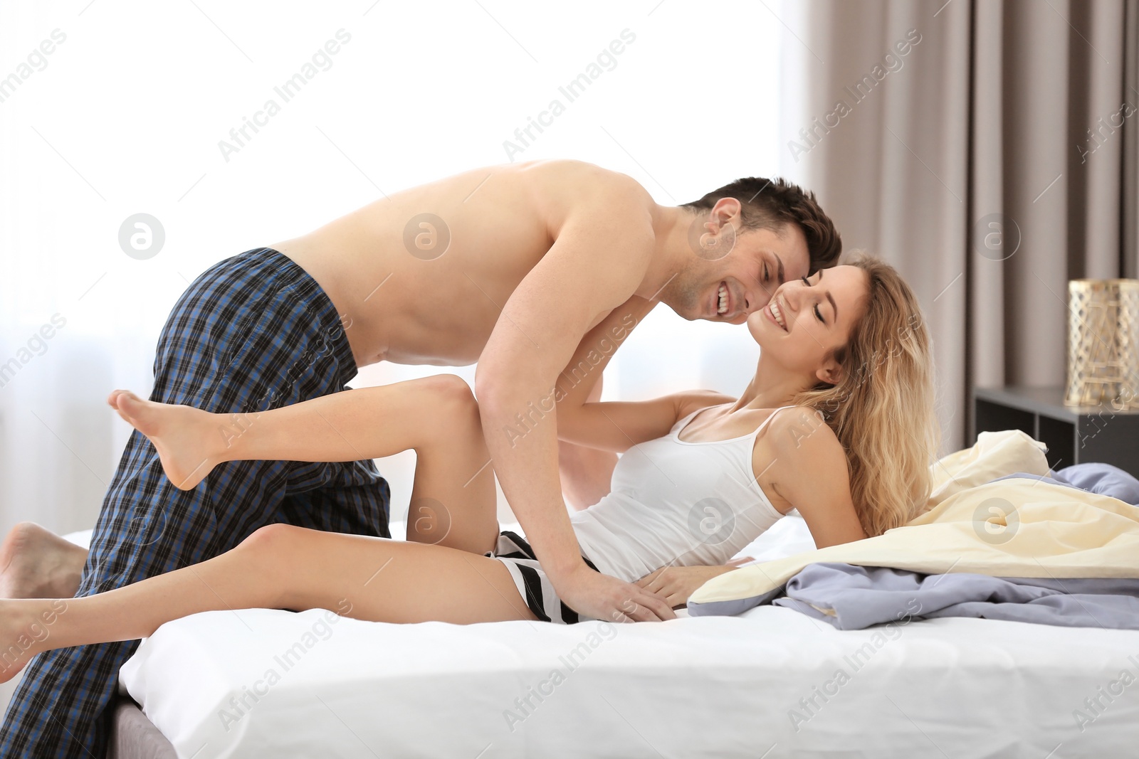 Photo of Sexy young couple being intimate in bedroom