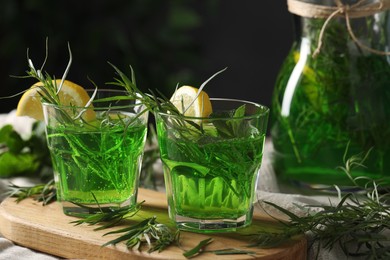 Photo of Refreshing tarragon drink with lemon slices on table