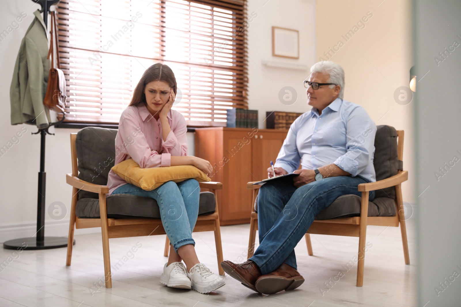 Photo of Professional psychotherapist working with patient in office