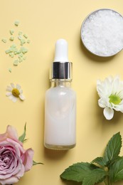 Photo of Flat lay composition with cosmetic serum on pale yellow background