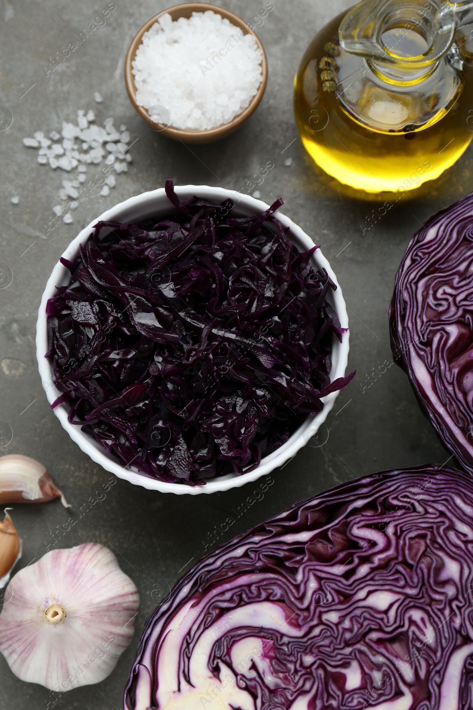 Photo of Tasty red cabbage sauerkraut and different ingredients on light grey table, flat lay