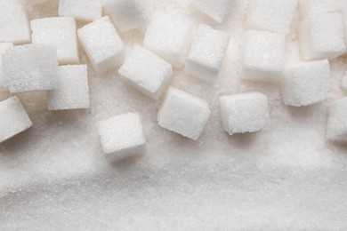 Different types of white sugar as background, top view