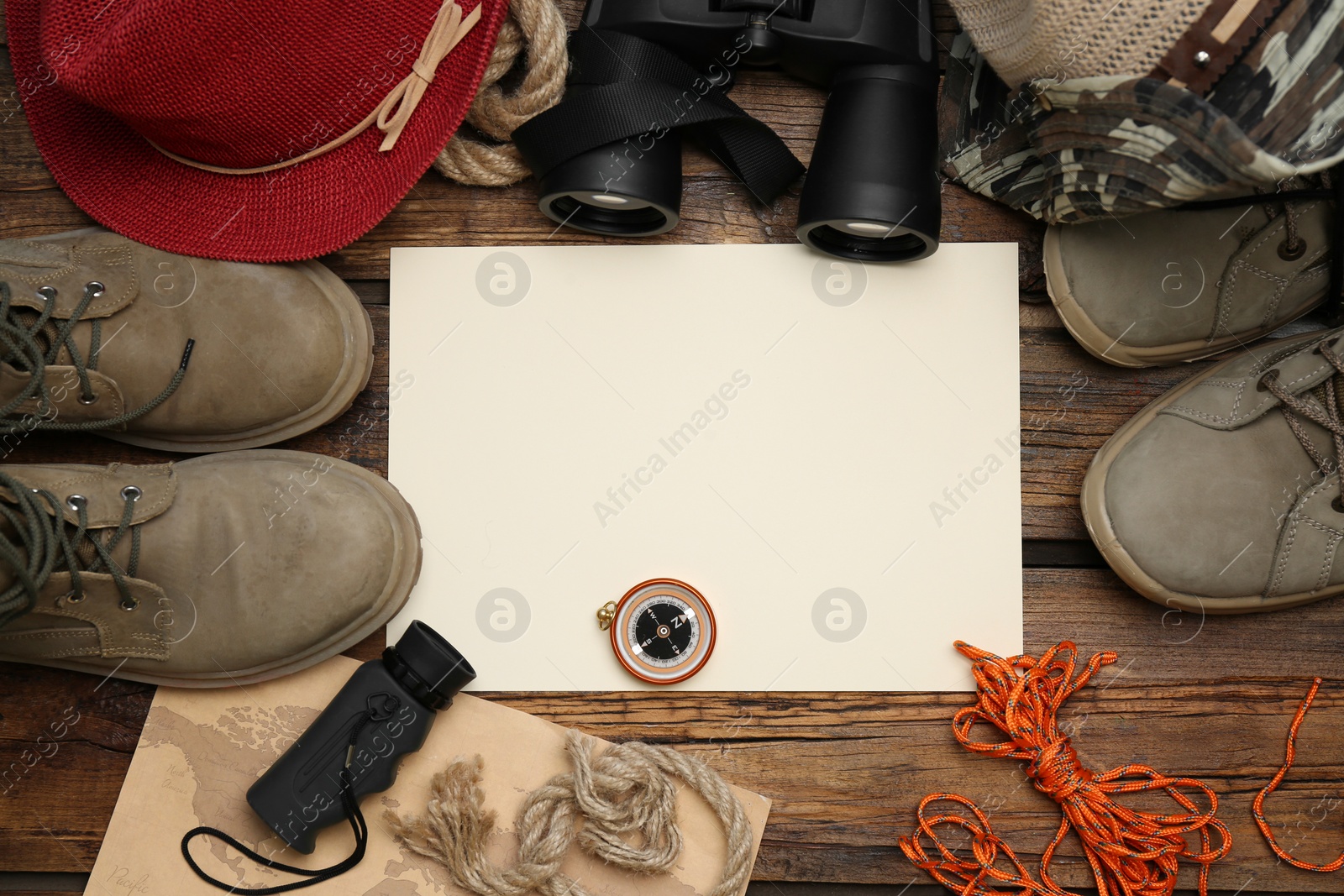 Photo of Flat lay composition with camping equipment on wooden background