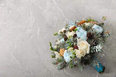 Photo of Beautiful wedding winter bouquet on grey table, top view. Space for text
