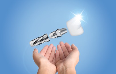 Woman demonstrating dental implant on light blue background, closeup