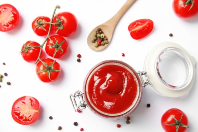 Composition with tasty homemade tomato sauce on white background, top view